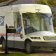 A rendering of the USPS next generation vehicle delivering mail on a suburban street.